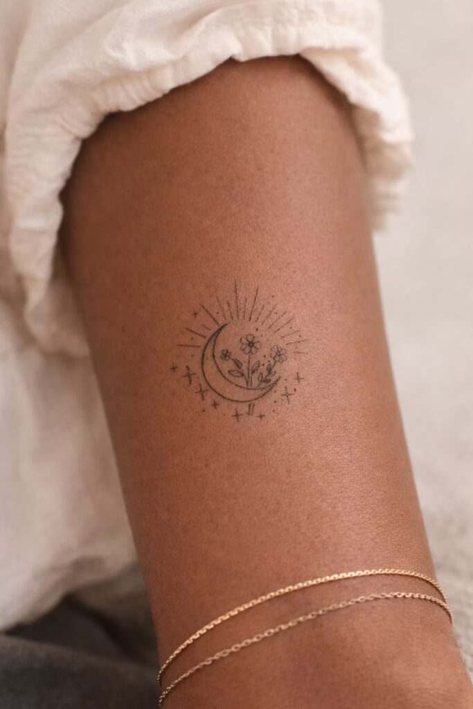 Crescent Moon and Sunburst Floral Tattoo