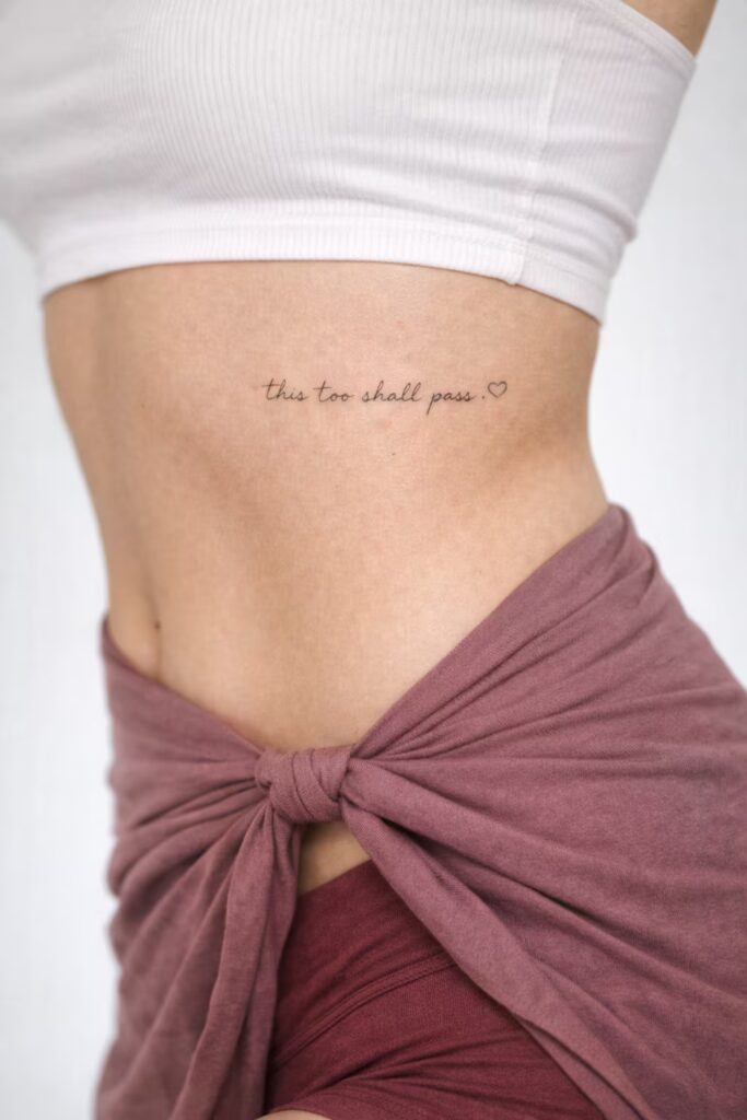 “This Too Shall Pass” Script Side Tummy Tattoo for Women
