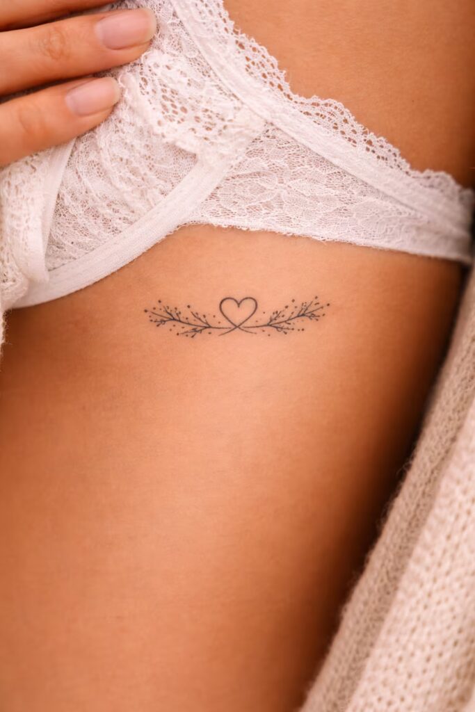 Floral Ribcage Love Symbol Tattoo