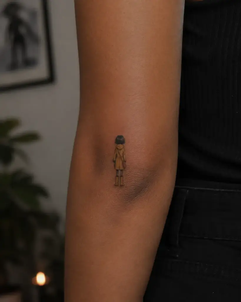 The Coraline Walking Away Arm Tattoo